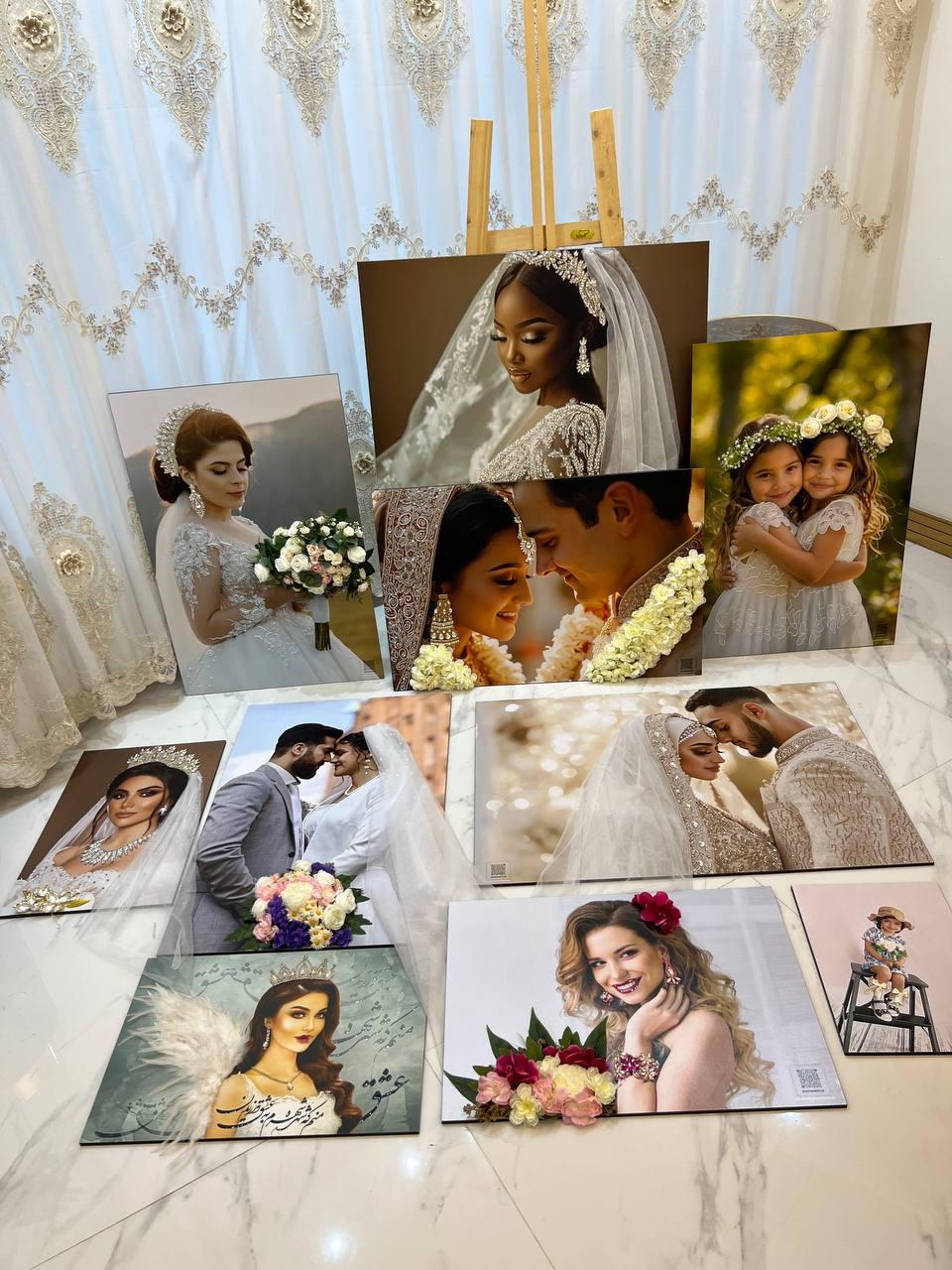 An artfully arranged display of bridal portrait prints and floral styling details